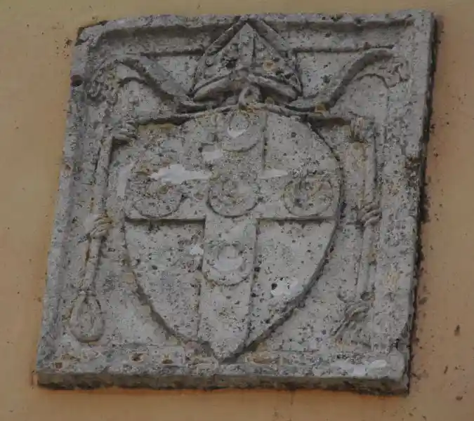 Cross inside a heart-like shape with a crown on top